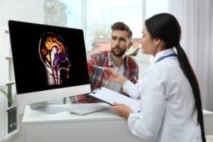 A doctor showing a patient images of his brain.