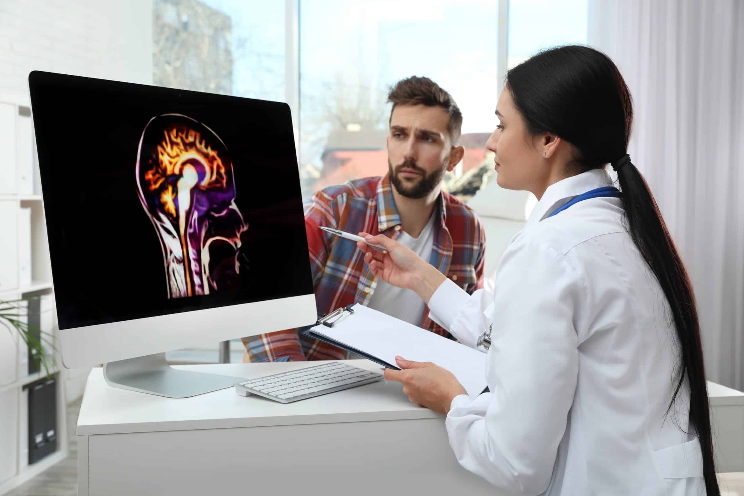 A doctor showing a patient images of his brain.