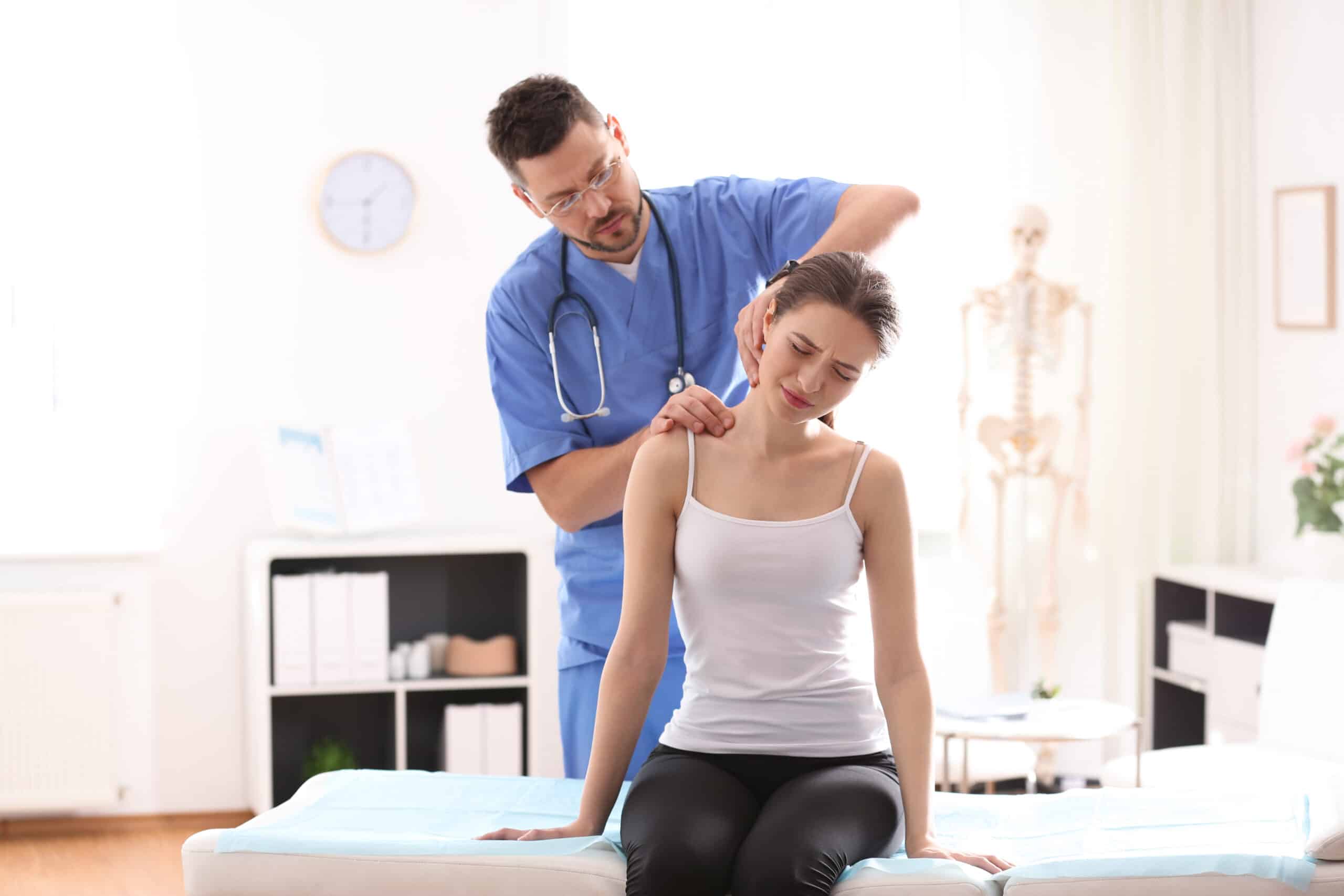 Doctor examining a woman's chronic neck pain, in need of Radiofrequncy Ablation treatment