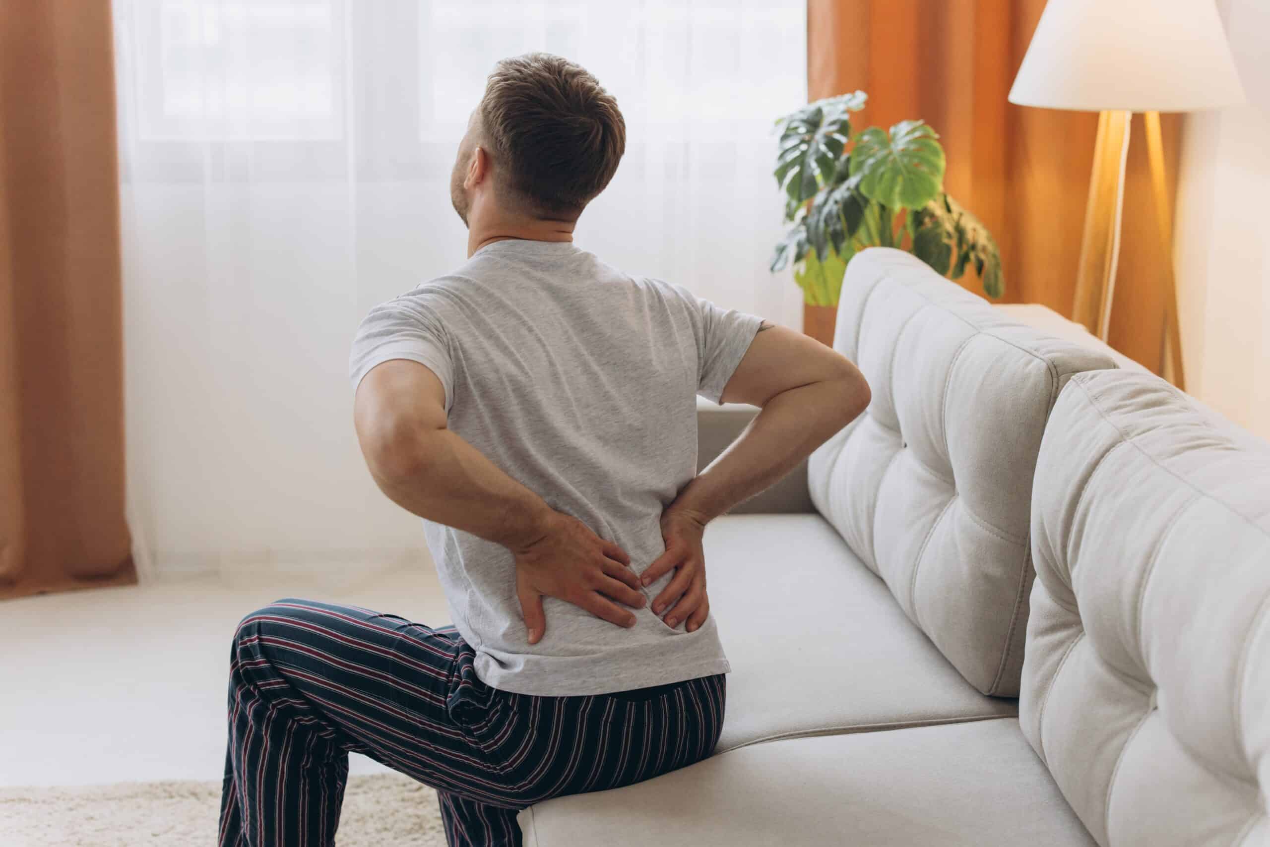 Man clutching his lower back in need of Epidural Steroid Injections to relieve chronic pain