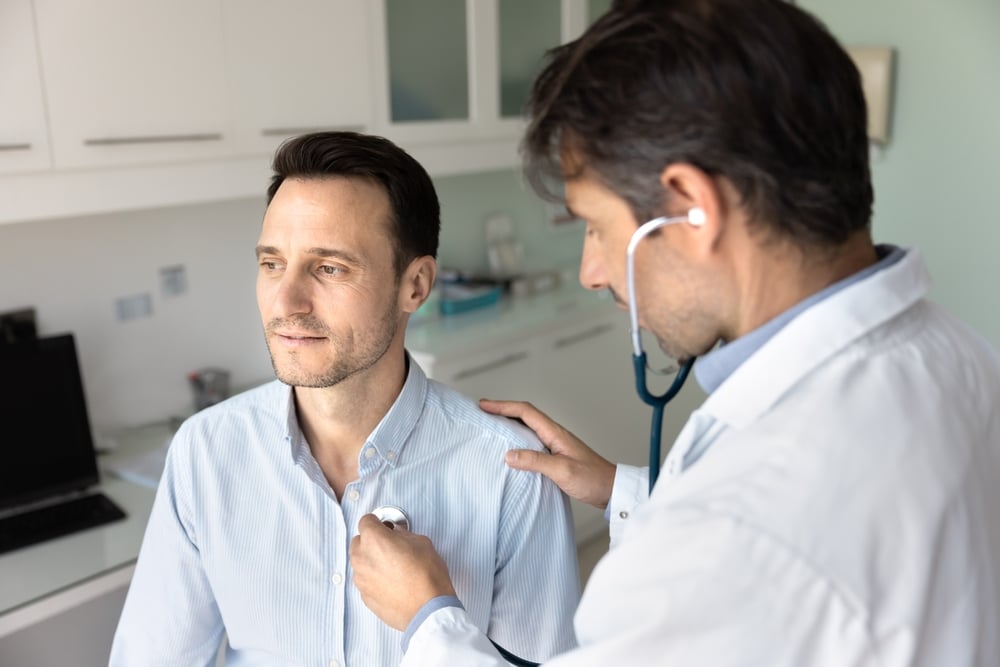 Middle-aged man having a consultation with his doctor about vagus nerve stimulation to help prevent seizures.
